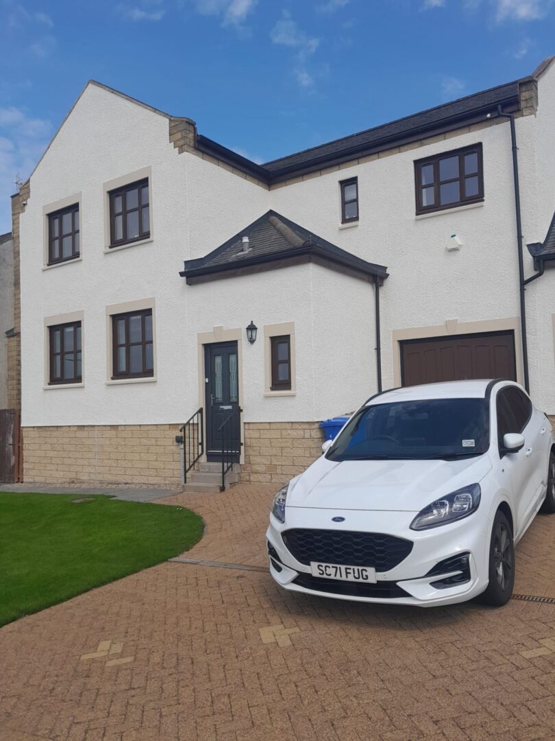 house with car in front of her